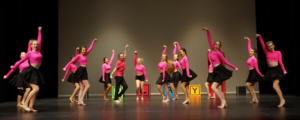 Dancers performing jazz on stage