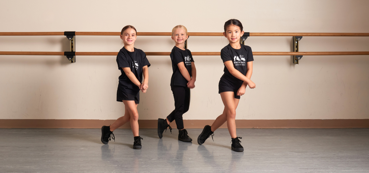 Dancers cross and step in pre-hip hop class