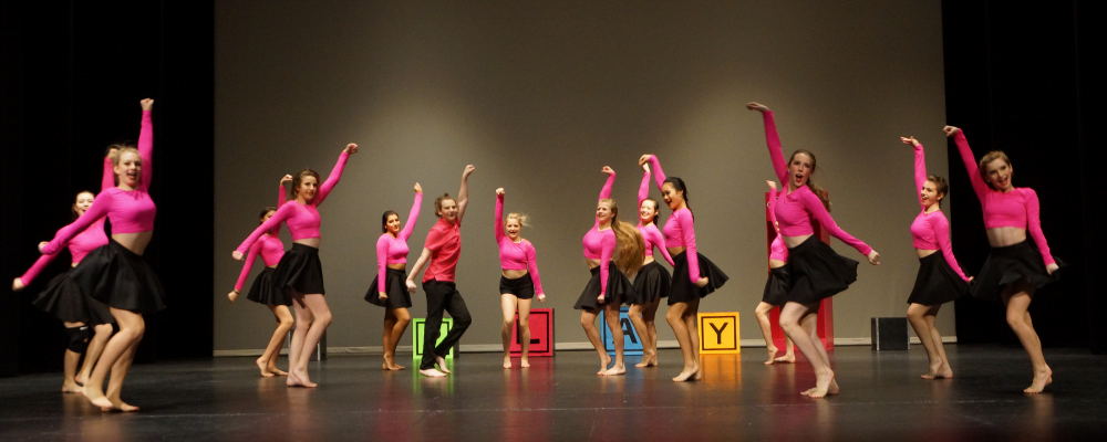 Dancers performing jazz on stage